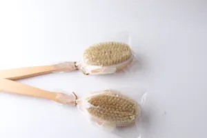 Detail view of natural bristle long handle wooden bath brush, soft boar hair exfoliating scrubber.