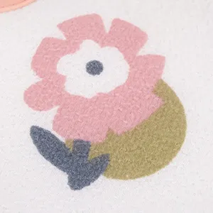 Close-up detail of bath glove with cute flower embroidery pattern, soft fabric texture.