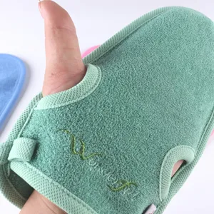 Green exfoliating bath glove detail close-up, plant fiber scrub mitt for daily shower use