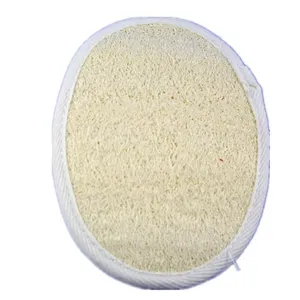 Close-up detail of natural loofah bath sponge with white fabric edge for gentle skin exfoliation.