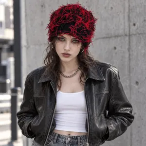 Closeup of a unique black and red fringe knit beanie hat showcasing street style texture and design.