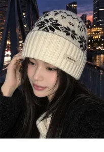 Close-up detail of the cozy 100% wool winter beanie with Nordic snowflake knit pattern.