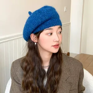 Detailed view of the blue knitted wool beret hat, showcasing soft texture and elegant style.