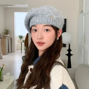 Grey knitted beret for women, stylish winter cozy wool hat with metal detail elegant and chic.