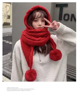 Detail view of the cozy red knitted hooded scarf featuring cute pom-poms and warm design.