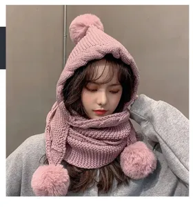 Pink knitted hooded scarf detail view, cozy winter warm plush pom-pom beanie hat.