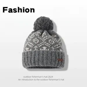 Detailed close-up of winter warm pom-pom knit hat, thick wool jacquard cozy style.