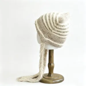 Detailed view of the cozy fuzzy striped knitted beanie featuring cute cat ears and long tassel.