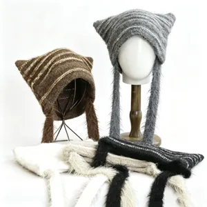 Detailed view of winter knitted cat ear hat with stylish stripes and long ribbon earflaps.