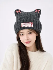 Detailed view of the cute dark grey knitted cat ear hat featuring charming red checkered bows.