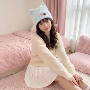 Sweet cute cat ear knit hat detail shot, warm wool material, light blue style worn by model.
