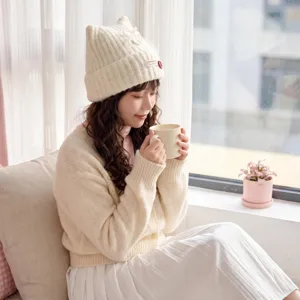 Cute cat ear knit hat detail shot, warm autumn winter woolen cap for women styling.