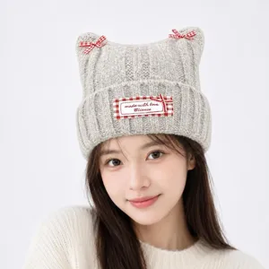 Cute cat ear knitted hat with red plaid bows and label, warm winter beanie for women and girls.