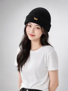 Close-up detail of the black knit beanie featuring cute animal embroidery, warm and stylish design.