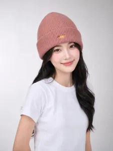 Pink knitted beanie featuring cute animal embroidery detail, soft winter warm pullover hat.
