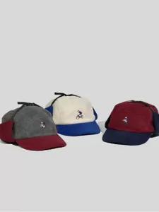 Cappello invernale in pile con design color block, paraorecchie e dettaglio di ricamo.