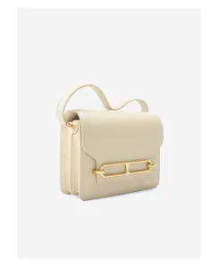 Details of minimalist beige leather crossbody bag with chic metal lock clasp, stylish daily wear.