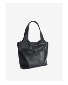 Close-up detail of the black leather tote bag showing embossed monogram logo and smooth texture.
