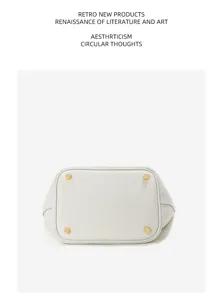 Detailed bottom view of the genuine leather bucket bag showing metal studs and texture.