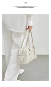 Minimalist leather bowling bag with long handles, chic shoulder purse for women daily style.