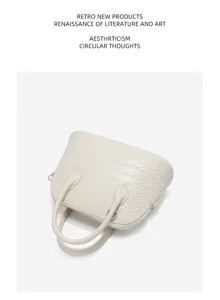 Sac à main en cuir effet crocodile, détail élégant et bowling bag beige pour femme au quotidien.