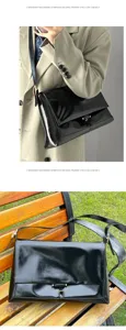 Black patent leather messenger shoulder bag for women, chic commuter flap bag with metal lock.