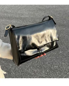 Black glossy genuine leather shoulder bag for women, stylish commuter messenger bag.