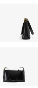 Black glossy leather shoulder bag detail, elegant minimalist strap and durable metal buckle.