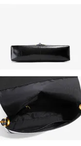Detailed view of the black glossy leather women's shoulder bag, showing the bottom and interior.