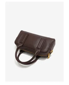 Detail shot of the dark brown genuine leather Boston bag zipper and handle construction.