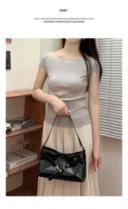 Black patent leather shoulder bag with buckle strap, chic underarm handbag for women commute.