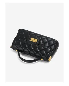 Detail view of black quilted leather handbag featuring chic gold hardware and top handle.