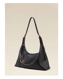 Minimalist black leather shoulder bag detail, elegant curved design with metal hardware.