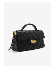 Detailed view of the black quilted leather crossbody bag with chic gold chain strap and lock.