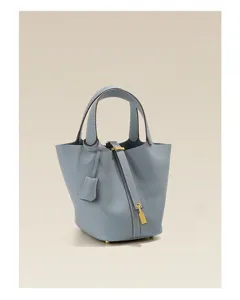 Light blue genuine leather bucket handbag for women, stylish minimalist daily top handle bag.