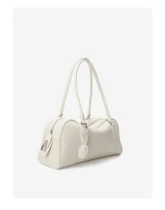Detailed view of the white leather bowling bag with long handles and structured silhouette.