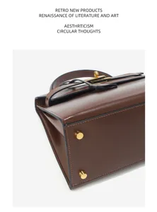 Détail de sac Kelly en cuir marron avec finition brillante et pieds en métal classique.