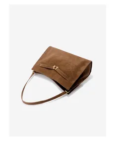 Brown suede shoulder bag detail, stylish retro underarm handbag with metal clasp closure.