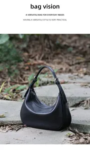 Detailed view of black leather crescent hobo bag, premium daily commuting shoulder bag.