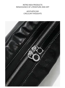 Close-up detail of premium crinkled leather handbag zipper and metallic ring pull hardware.