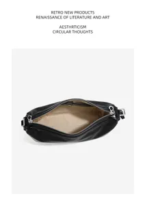Detailed top-down view of black genuine leather hobo shoulder bag with zipper and lining.
