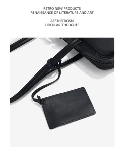 Genuine cowhide leather boston bag detail shot showing premium black texture and stylish strap.