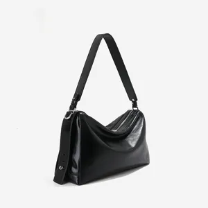 Genuine leather black hobo shoulder bag for women, versatile commuting baguette crossbody bag.