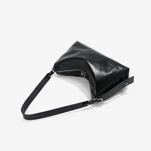 Black genuine leather underarm shoulder bag, stylish hobo baguette bag for women commuting.