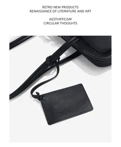 Black genuine leather women shoulder bag boston bag detail view with stylish strap and tag.