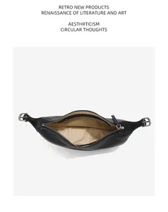 Detail view of black leather crescent hobo bag with zipper and soft interior lining.