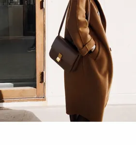 Detail view of a classic leather crossbody square bag, elegant daily commuting shoulder bag.