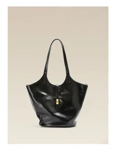 Detail view of black soft leather tote shoulder bag, minimalist bucket bag design with clasp.