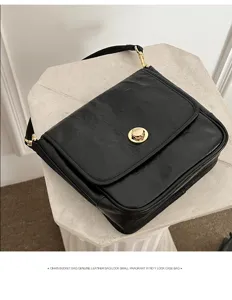 Black genuine leather shoulder bag detail, chic pleated underarm tote with metal lock.