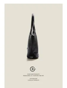 Detailed view of the black soft leather tote bag, showing profile side shape and straps.